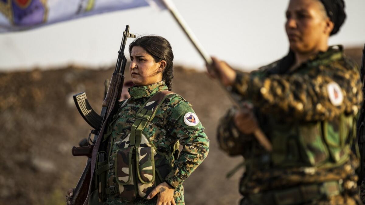 Members of the Bethnahrin Women Protection Forces (HSNB), an all-female Syriac-Assyrian paramilitary group under the umbrella of the Syrian Democratic Forces (SDF), line-up as they commemorate the fourth anniversary of their creation, in the countryside of the town of Tall Tamr in the northwestern Syrian province of Hasakah, on August 30, 2019.  Delil SOULEIMAN / AFP
