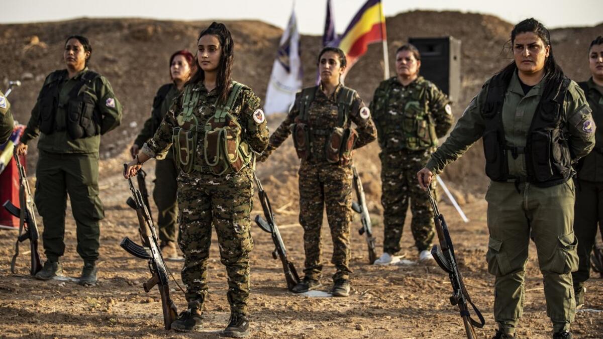 Members of the Bethnahrin Women Protection Forces (HSNB), an all-female Syriac-Assyrian paramilitary group under the umbrella of the Syrian Democratic Forces (SDF), line-up as they commemorate the fourth anniversary of their creation, in the countryside of the town of Tall Tamr in the northwestern Syrian province of Hasakah, on August 30, 2019.  Delil SOULEIMAN / AFP