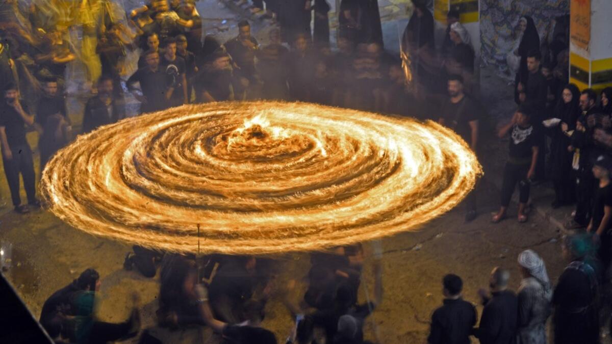 Iraqi Shiite Muslims perform mourning rituals during a ceremony marking the 7th day of Muharram as part of Ashura in the Iraqi holy city of Najaf. Ashura, one of the holiest days in Shiite Islam, commemorates the seventh century killing of Prophet Mohammed's grandson Imam Hussein. Haidar HAMDANI / AFP