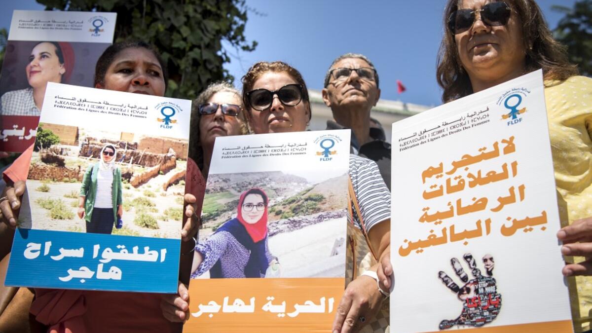 Demonstrators hold up signs showing the portraits of Hajar Raissouni, a Morrocan journalist of the daily newspaper Akhbar El-Youm, with captions reading in Arabic (L to R) "Free Hajar", "Freedom for Hajar", "No to the criminalisation of consensual relations between adults", as they gather outside a courthouse holding her trial on charges of abortion in the capital Rabat on September 9, 2019. FADEL SENNA / AFP