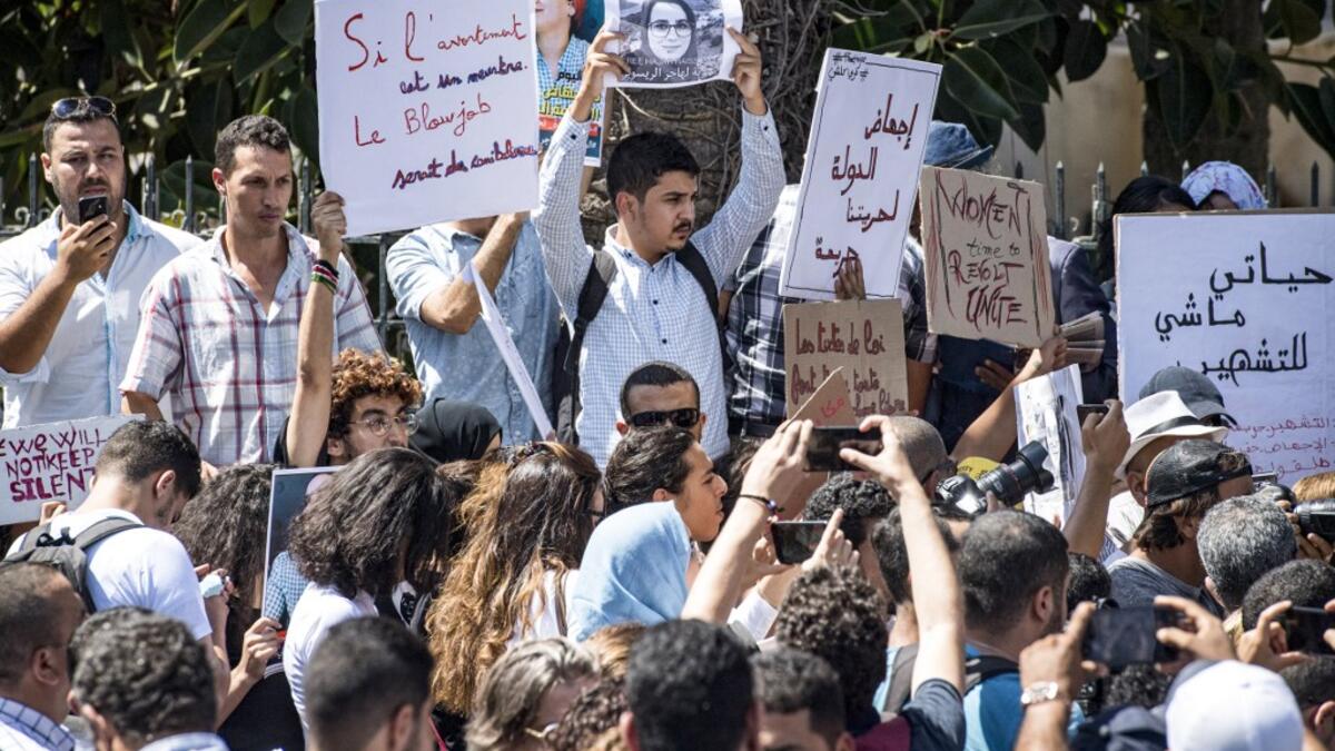 Demonstrators hold up signs showing the portraits of Hajar Raissouni, a Morrocan journalist of the daily newspaper Akhbar El-Youm. FADEL SENNA / AFP