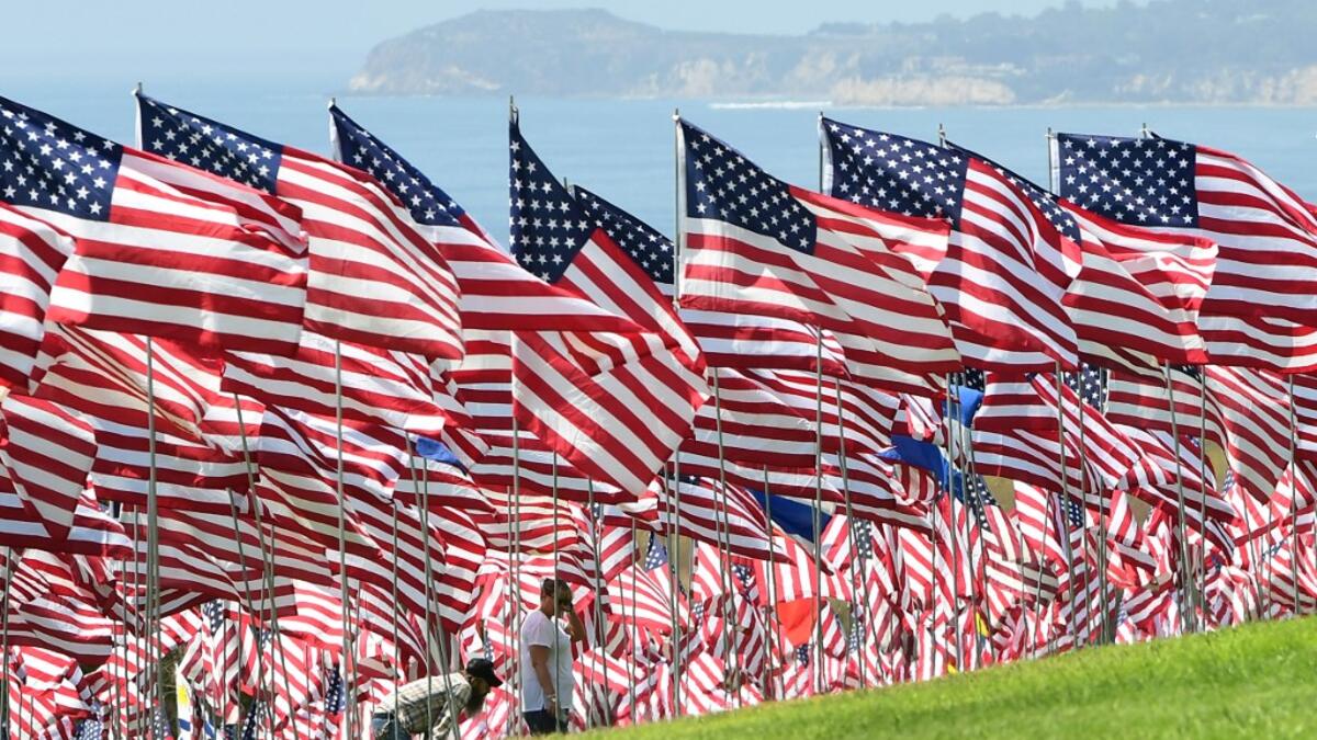 People visit the Pepperdine Wave of Flags display at Pepperdine University in Malibu, California, commemorating those who died in the September 11, 2001 attacks with 2,977 flags. Frederic J. BROWN / AFP