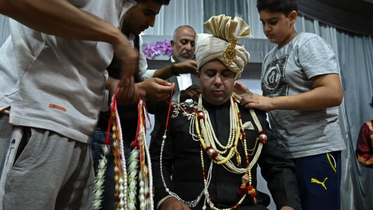 In this photo taken on September 15, 2019, a groom is garlanded by relatives and friends before leaving for his bride's home in Kashmir's Baramulla district, north of Srinagar. TAUSEEF MUSTAFA / AFP