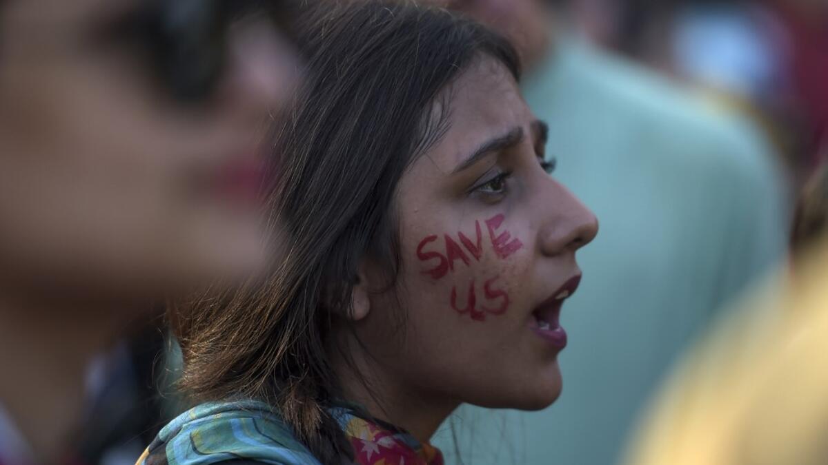 A youth shouts slogans as she sits during a climate strike to protest against governmental inaction towards climate breakdown and environmental pollution, part of demonstrations being held worldwide in a movement dubbed "Fridays for Future", in Islamabad on September 20, 2019. AAMIR QURESHI / AFP