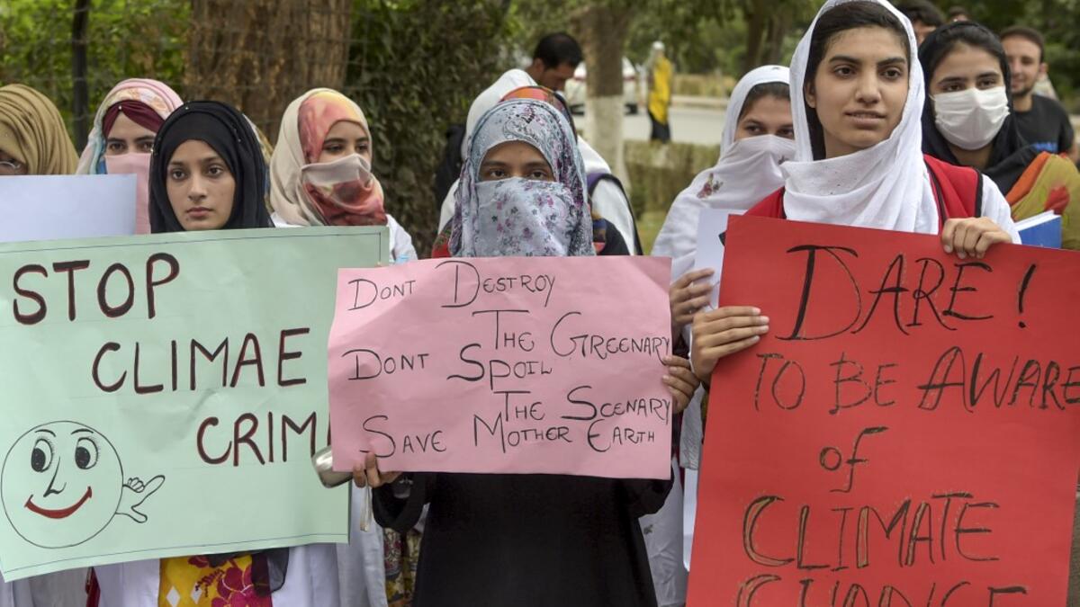 Students hold placards as they march for a climate strike to protest against governmental inaction towards climate breakdown and environmental pollution, part of demonstrations being held worldwide in a movement dubbed "Fridays for Future", in Peshawar on September 20, 2019. ABDUL MAJEED / AFP