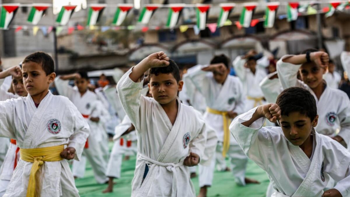 Young Palestinian karatekas demonstrate their skills during a Karate promotion ceremony at a sporting centre in the Rafah camp for Palestinian refugees in the southern Gaza Strip on September 20, 2019. SAID KHATIB / AFP
