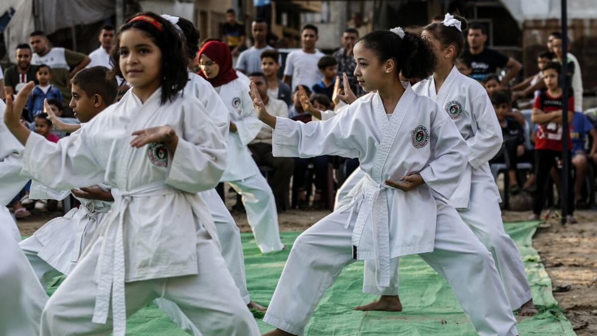 Young Palestinian karatekas demonstrate their skills during a Karate promotion ceremony at a sporting centre in the Rafah camp for Palestinian refugees in the southern Gaza Strip on September 20, 2019. SAID KHATIB / AFP