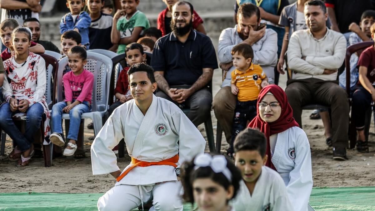 Young Palestinian karatekas attend a Karate promotion ceremony at a sporting centre in the Rafah camp for Palestinian refugees in the southern Gaza Strip on September 20, 2019. SAID KHATIB / AFP
