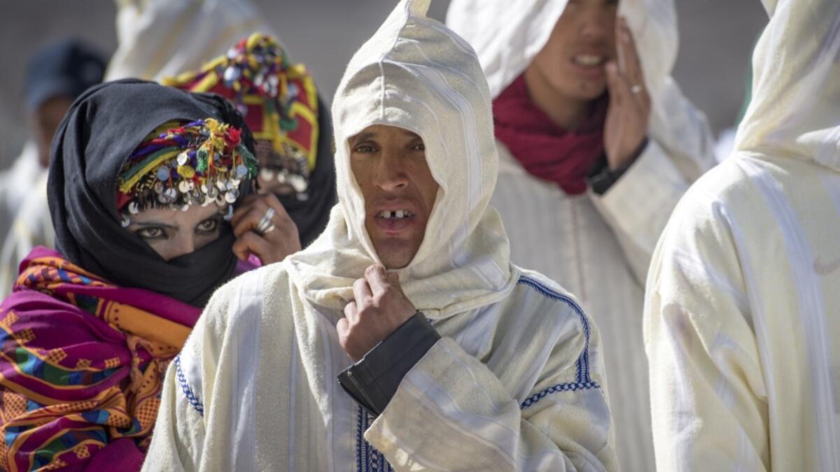 Young Amazigh (Berber) men and women wait for their wedding ceremony during the annual "Engagement Moussem" festival near the village of Imilchil in central Morocco's high Atlas Mountains on September 21, 2019. Each year in the High Atlas Mountains hamlet of Ait Amer, tribes celebrate with dances and music, the collective wedding of young Amazigh couples during the traditional festival of "Engagement Moussem". FADEL SENNA / AFP