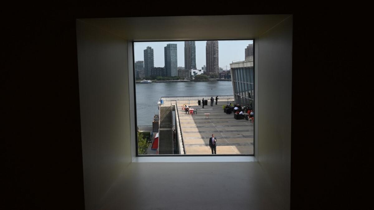 People take a break on the patio during the 74th Session of the General Assembly during the United Nations General Assembly September 26, 2019 in New York. TIMOTHY A. CLARY / AFP
