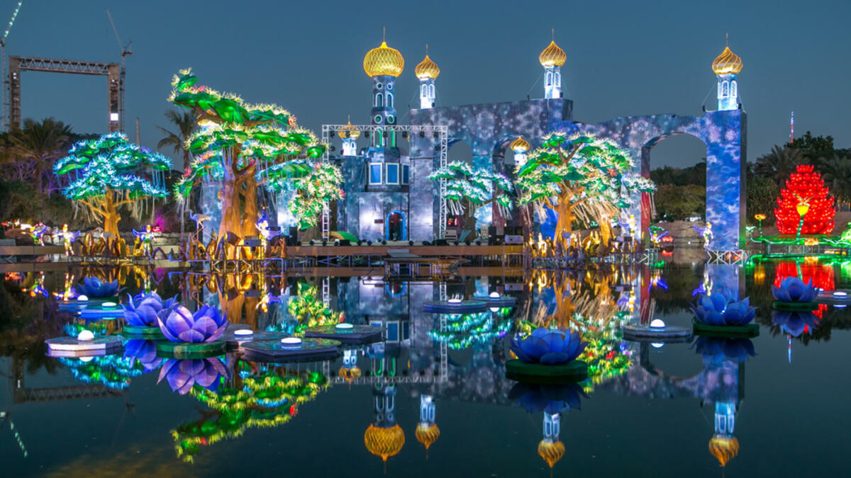 Lake with flowers and castle. Newly opened Dubai Glow Garden day to night transition timelapse is a state of Art architecture featuring environment friendly architecture, creating various structures. (Shutterstock/ File Photo)