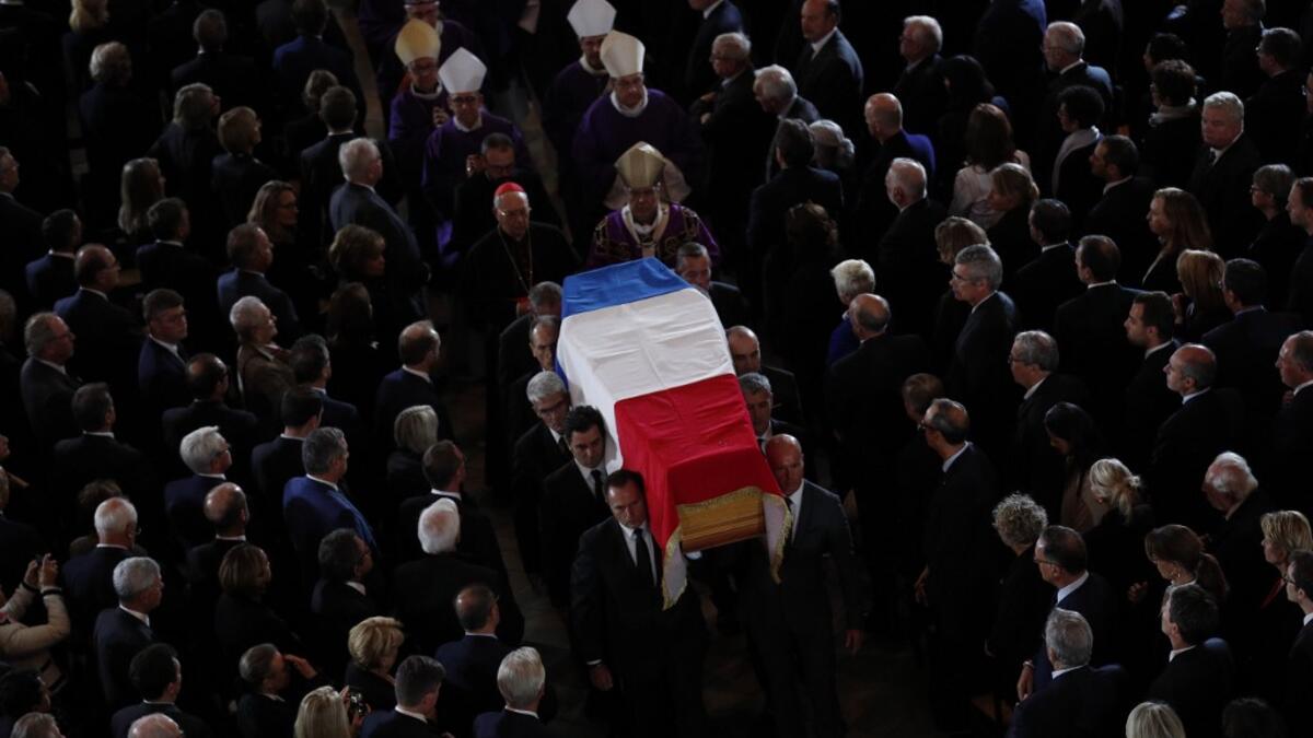 The coffin of the late French president Jacques Chirac is carried from the Saint Sulpice Church in the French capital Paris to a waiting hurst following his funeral service on September 30, 2019.  Francois Mori / POOL / AFP