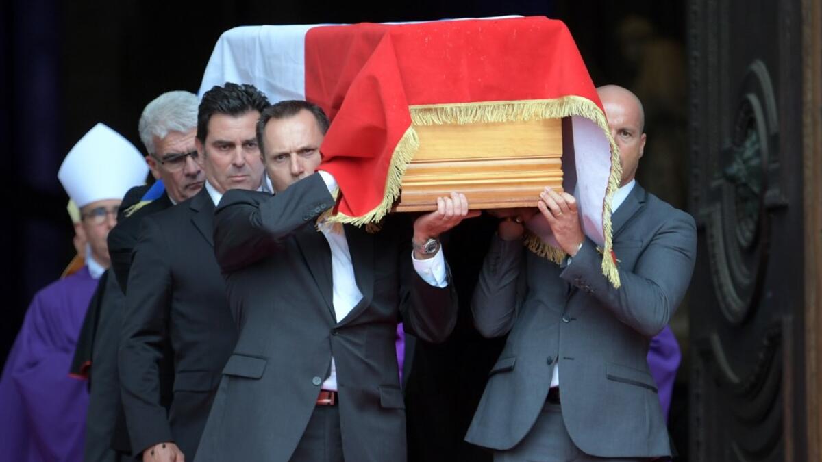 The coffin of former French President Jacques Chirac, covered with the French national flag, is carried by pall bearers as it leaves the Saint-Sulpice church in Paris Eric FEFERBERG / AFP