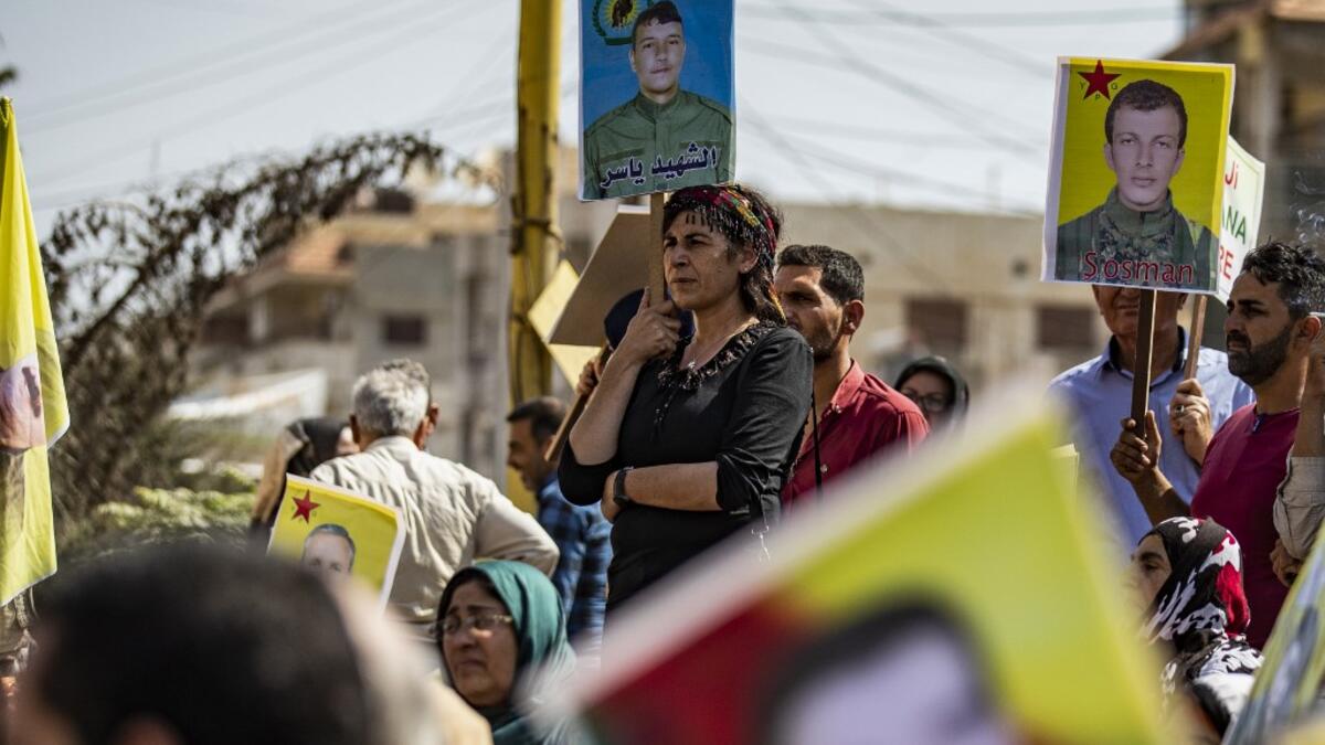Syrian Kurds demonstrate in front of the United Nations offices in the Kurdish-majority city of Qamishli in northeast Syria on October 2, 2019 over their exclusion from the UN-backed constitutional committee. The United Nations on September 23 announced the long-awaited formation of the committee which includes the government and opposition, but it remained to be seen if the step could finally end the civil war. Delil SOULEIMAN / AFP