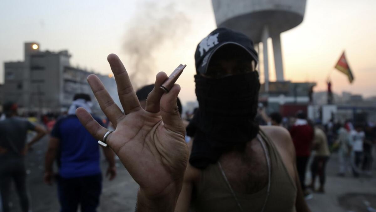 An Iraqi protester displays bullet casings during a demonstration against state corruption, failing public services and unemployment at Tayaran square in Baghdad on October 2, 2019. Iraq's president and the United Nations urged security forces to show restraint after two protesters were killed in clashes with police that other top officials blamed on "infiltrators." AHMAD AL-RUBAYE / AFP