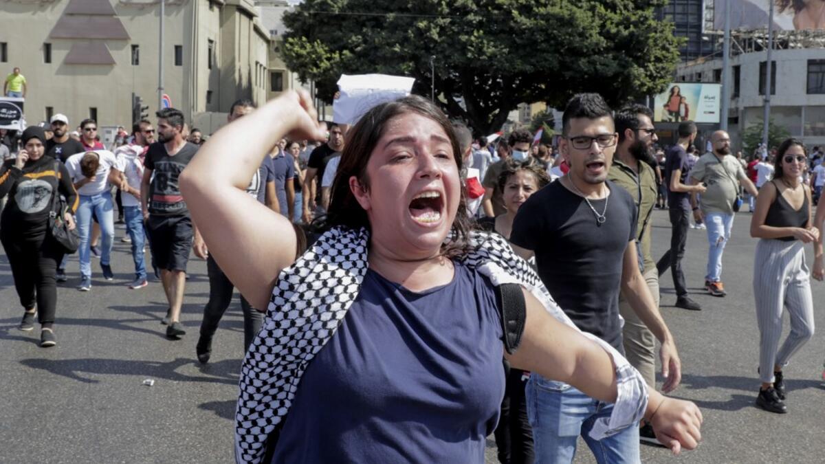 A Lebanese protester shouts slogans during a demonstration near central Beirut's Martyr Square on October 6, 2019. Lebanese protested in the capital over increasingly difficult living conditions, amid fears of a dollar shortage and possible price hikes. ANWAR AMRO / AFP