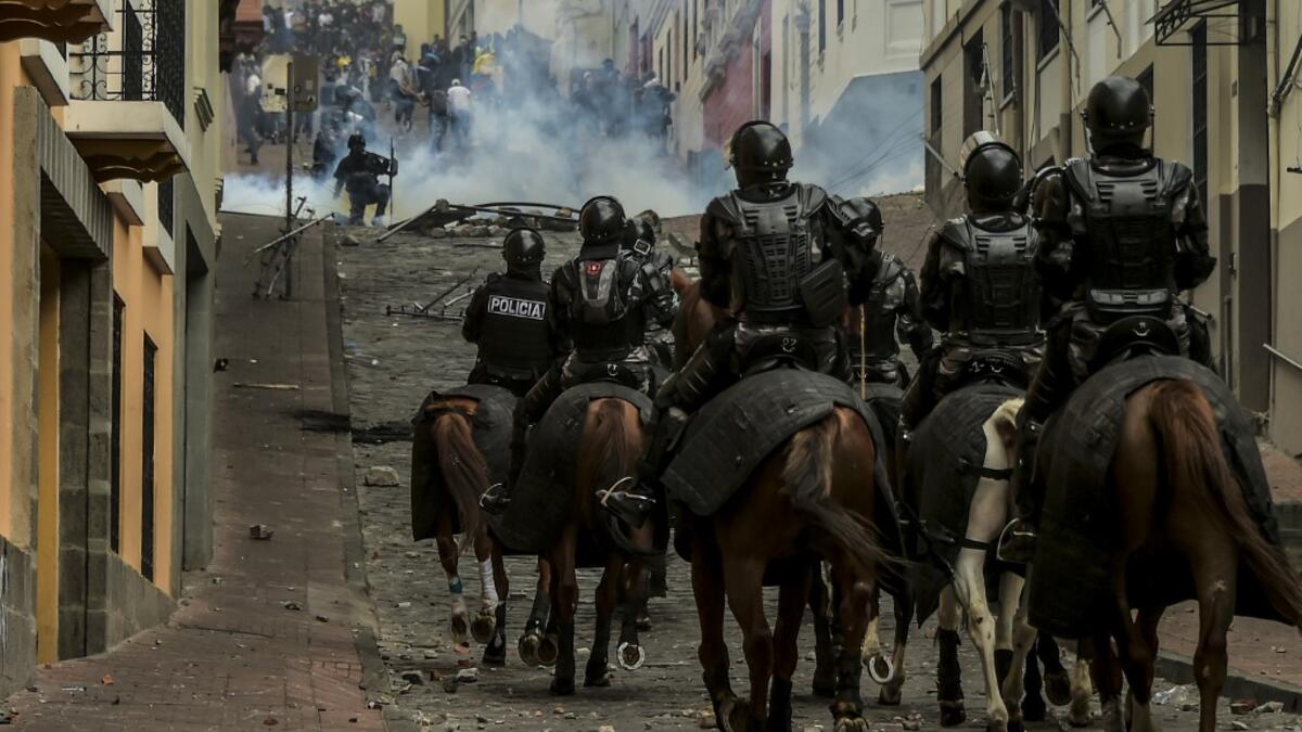 Mounted police confront demonstrators during clashes in Quito as thousands march against Ecuadorean President Lenin Moreno's decision to slash fuel subsidies, on October 9, 2019. Rodrigo BUENDIA / AFP
