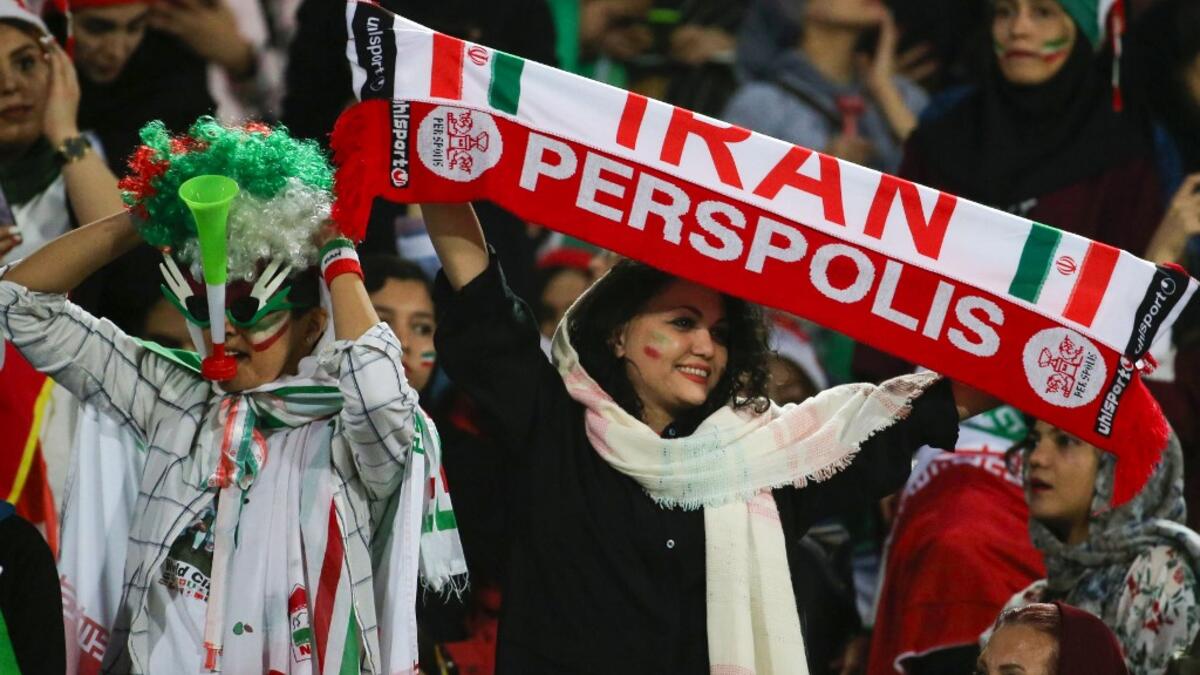 The Islamic republic has barred female spectators from football and other stadiums for around 40 years, with clerics arguing they must be shielded from the masculine atmosphere and sight of semi-clad men. Women fans are attending the football match freely for the first time in decades, after FIFA threatened to suspend the country over its controversial male-only policy.  ATTA KENARE / AFP