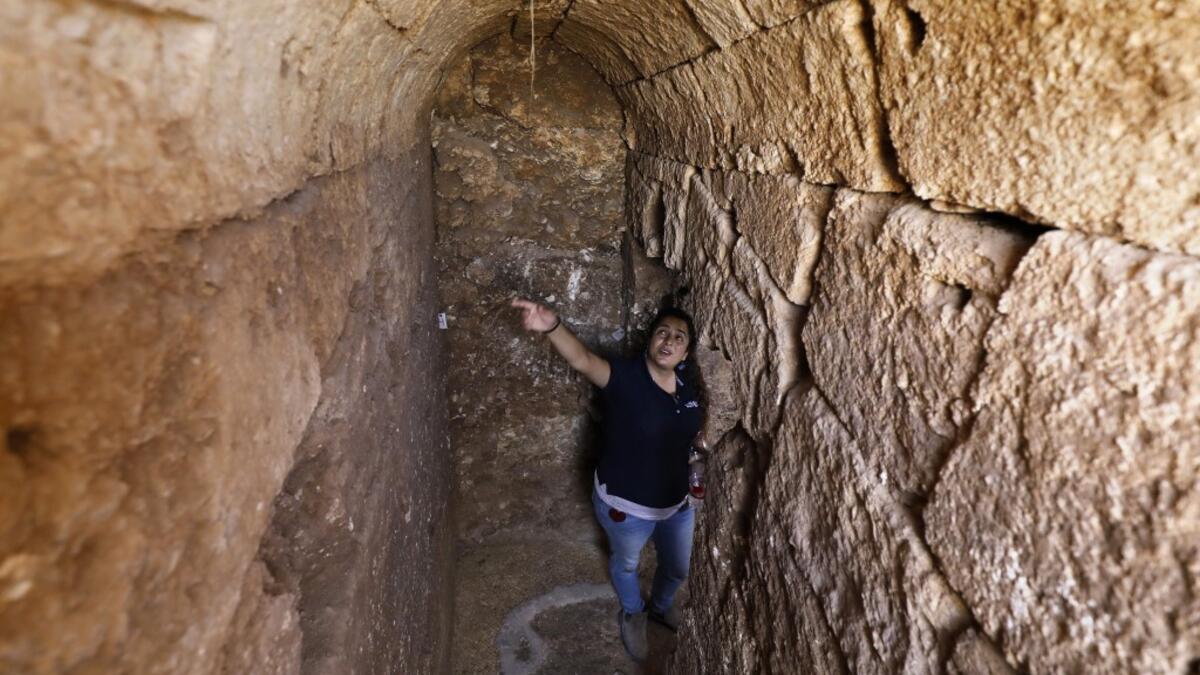 Timnah Goloubin, an archaeologist with the Israel Antiquities Authority, shows on October 23 2019 the ancient church crypt in the Israeli town of Bet Shemesh. A magnificent 1500-year-old church, decorated with spectacular mosaic floors and Greek inscriptions, was discovered during a three-year excavation near a residential area. MENAHEM KAHANA / afp