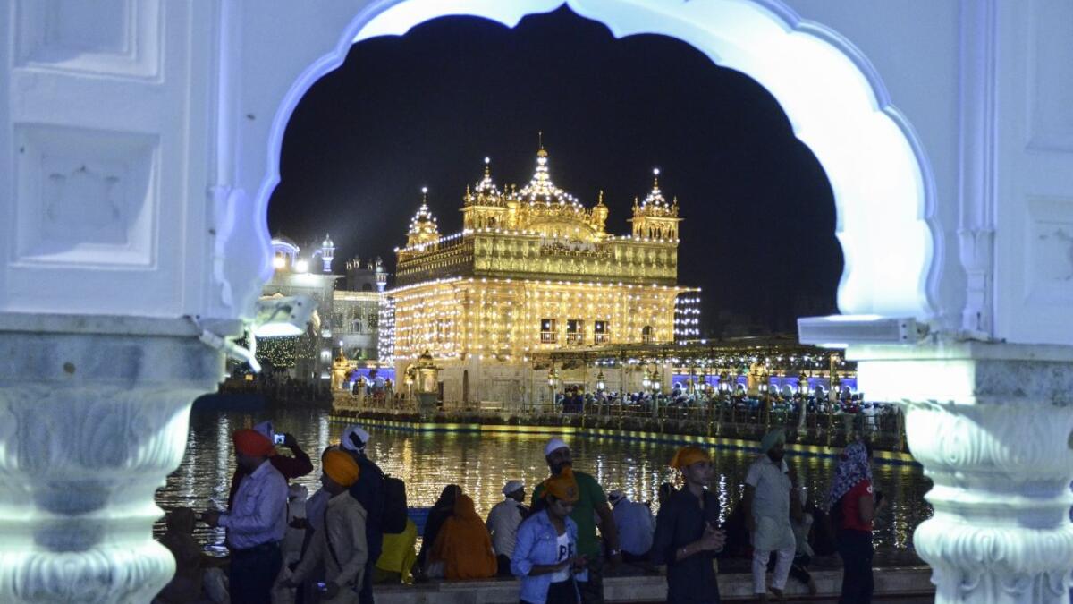 Indian Sikh devotees pay their respects on the eve of "Bandi Chhor Divas" or "Diwali" at the illuminated Golden Temple, in Amritsar on October 26, 2019. Sikhs celebrate 'Bandi Chhor Divas', also on the same day as the Hindu festival of Diwali, to mark the historic return of the sixth Guru, Guru Hargobind NARINDER NANU / AFP