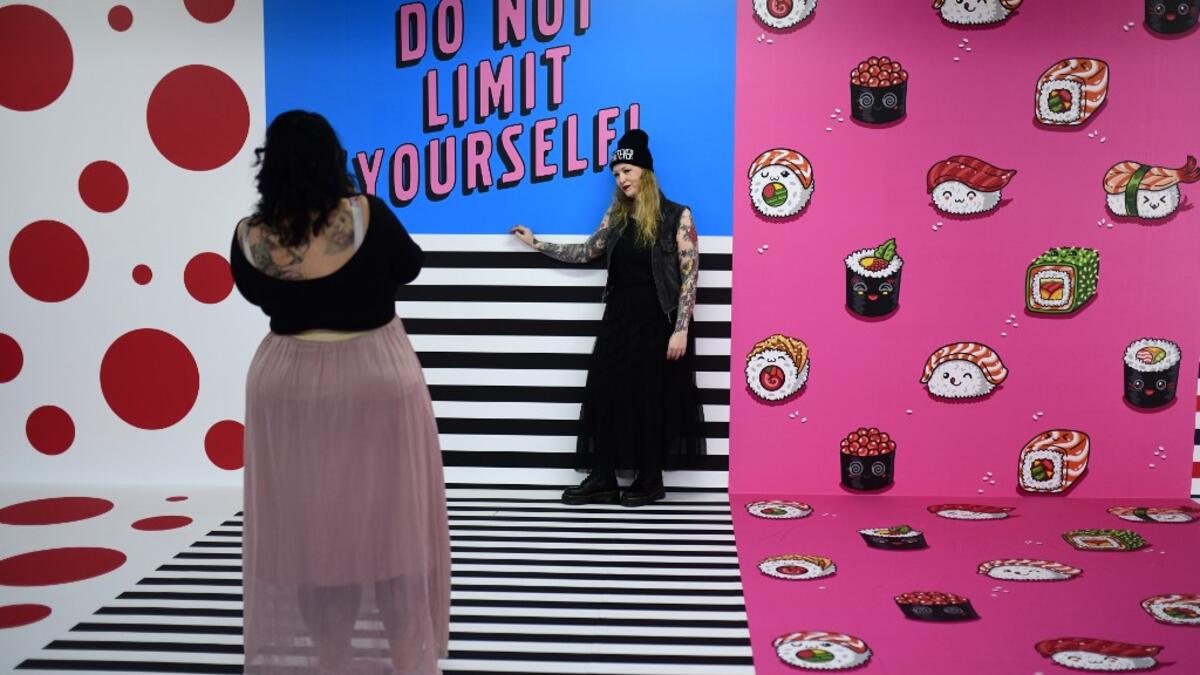 A woman is being photographed at the "Supercandy Pop-Up Museum Vol. 2" in Cologne, western Germany on November 1, 2019. It is an interactive museum and offers a photo backdrop for social media at 25 stations. INA FASSBENDER / AFP