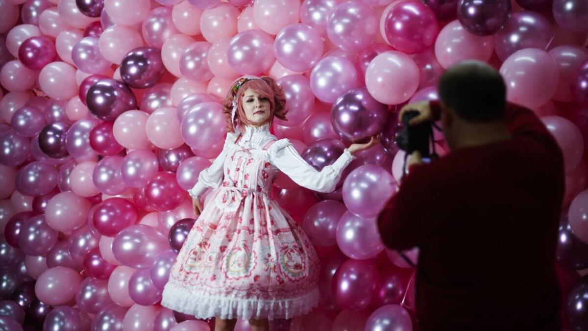 Instagram influencer "Anmaykaa" is being photographed at the "Supercandy Pop-Up Museum Vol. 2" in Cologne, western Germany on November 1, 2019. It is an interactive museum and offers a photo backdrop for social media at 25 stations. INA FASSBENDER / AFP