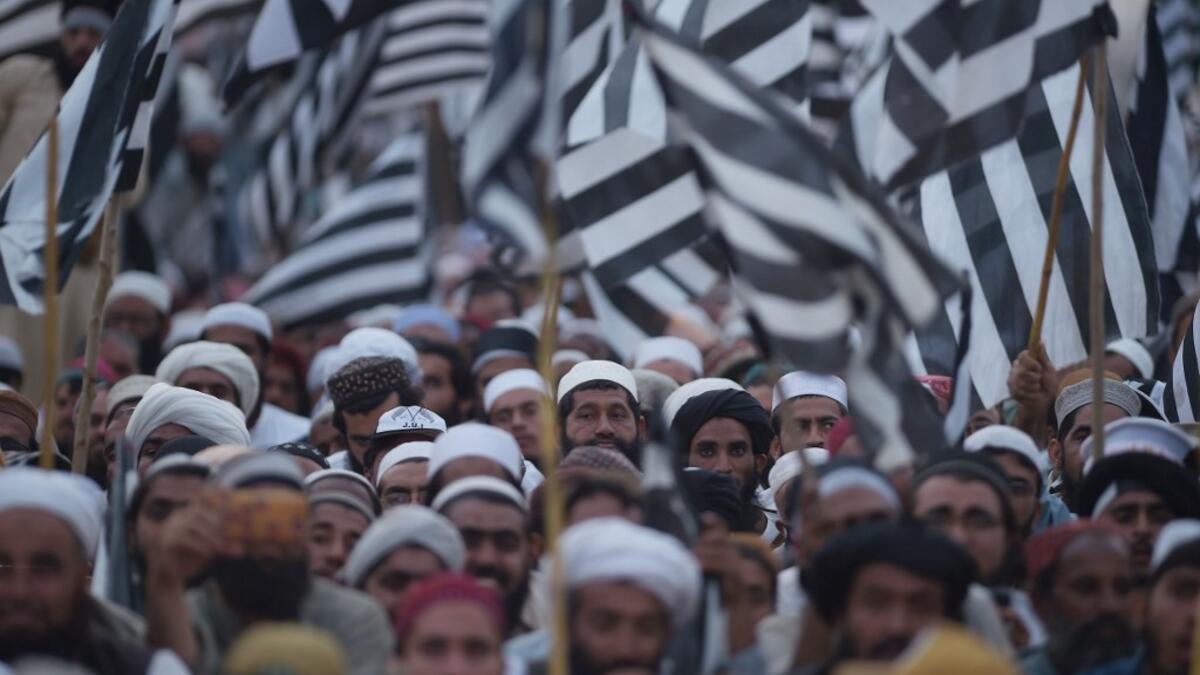 Activists of Islamic political party Jamiat Ulema-e-Islam (JUI) wave party flags during an anti-government "Azadi (Freedom) March" in Islamabad on November 2, 2019. Tens of thousands of Islamists rallied alongside opposition supporters in Pakistan's capital Friday, as the firebrand cleric leading the protests called on Prime Minister Imran Khan's government to step down within 48 hours. FAROOQ NAEEM / AFP