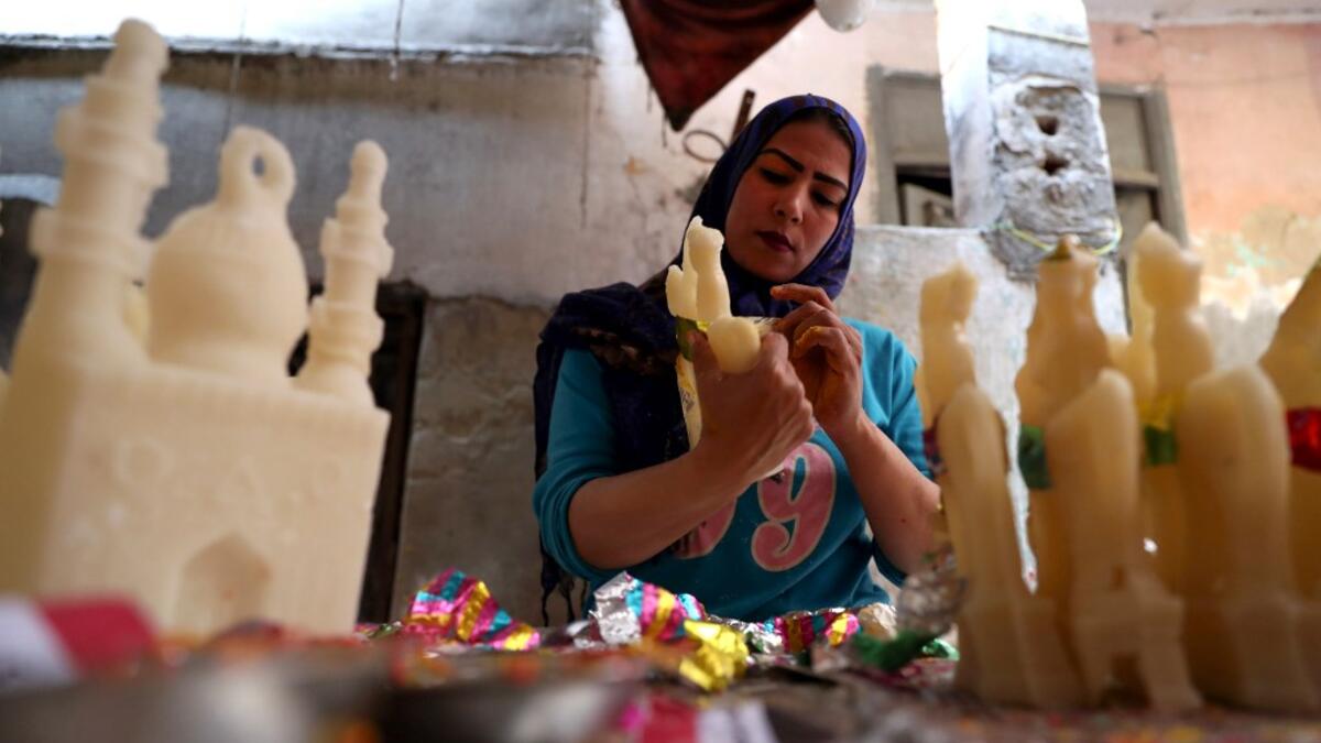 An Egyptian woman decorates traditional sugar statuettes in the capital Cairo on November 2, 2019, ahead of celebrations of the Muslim Prophet Mohammed's birthday, known as "Al Mawlid Al Nabawi". Prophet Mohamed was born in Saudi Arabia's arid mountainous city of Mecca, the holiest in Islam, some 1490 years ago. Sunni Muslims in many parts of the world celebrate his birthday on the 12th day of the third month of the Islamic calendar, which will fall this year on November 9th.  Mohamed el-Shahed / AFP