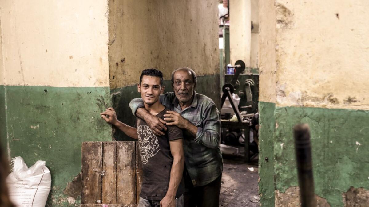 Egyptian confectioners pose for a picture at a candy factory in the capital Cairo on November 2, 2019, ahead of celebrations of the Muslim Prophet Mohammed's birthday, known as "Al Mawlid Al Nabawi". Prophet Mohamed was born in Saudi Arabia's arid mountainous city of Mecca, the holiest in Islam, some 1490 years ago. Sunni Muslims in many parts of the world celebrate his birthday on the 12th day of the third month of the Islamic calendar, which will fall this year on November 9th.  Mohamed el-Shahed / AFP