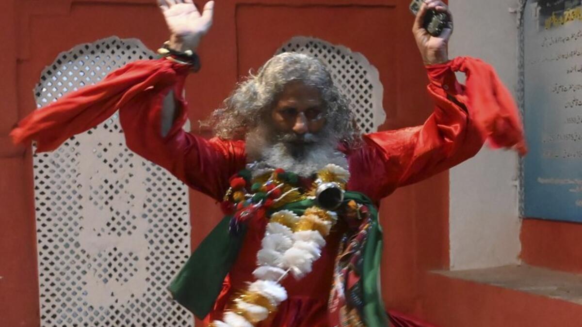 An Pakistani Muslim devotee performs at the shrine of Sufi saint Hazrat Mian Mir during the annual festival in Lahore on November 5, 2019, on his 396th birth anniversary. ARIF ALI / AFP