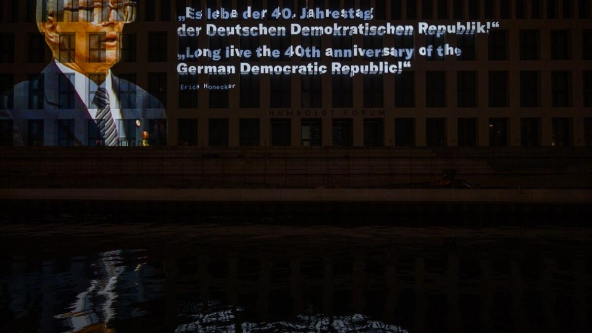 A photo showing east German leader Erich Honecker is projected on the Humboldt Forum building as part of of the festival week to celebrate the 30th anniversary of the November 9,1989 fall of the Berlin Wall, in Berlin on November 5, 2019. Germany marks three decades since the fall of the Berlin Wall this week with main celebrations on November 9, 2019. John MACDOUGALL / AFP