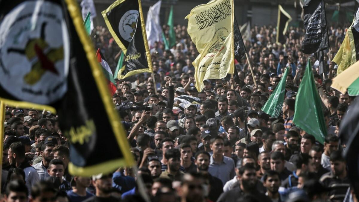 Mourners chant slogans as they carry the body of Palestinian Islamic Jihad senior leader Baha Abu Al-Ata during his funeral in Gaza City on November 12, 2019. Israel's military killed a commander of Palestinian militant group Islamic Jihad in a strike on his home in the Gaza Strip early, prompting retaliatory rocket fire and fears of a severe escalation in violence. MAHMUD HAMS / AFP