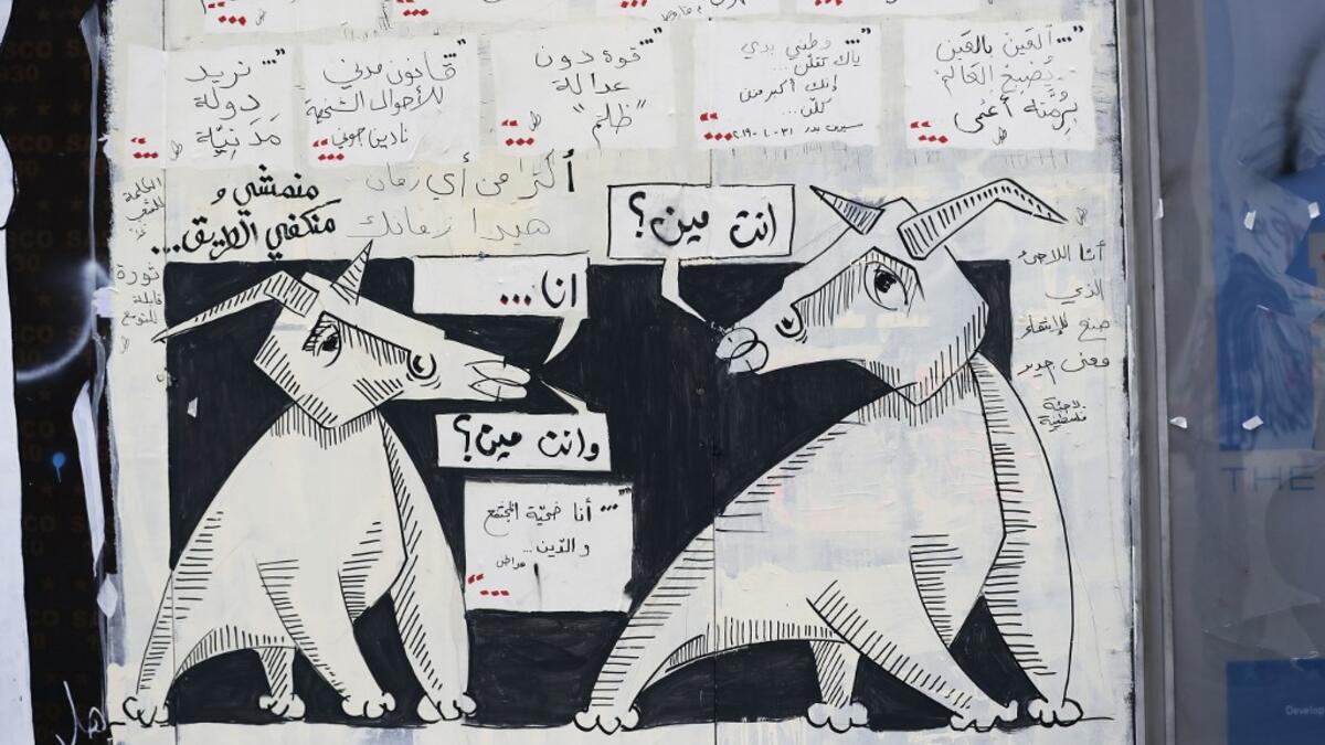 A graffiti is sprayed on a wall in Lebanon's capital Beirut on November 5, 2019. Since October 17, the chanting of tens of thousands of Lebanese denouncing the political elite have shaken the normally staid district around two Beirut squares, Martyrs' and Riad Al Solh. JOSEPH EID / AFP