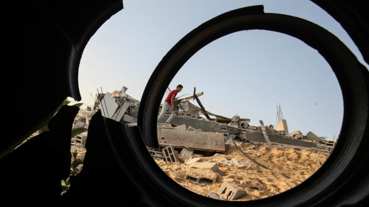 Palestinians check the remains of a house destroyed in an Israeli air strike at Khan Yunis in the southern Gaza Strip November 13, 2019. SAID KHATIB / AFP