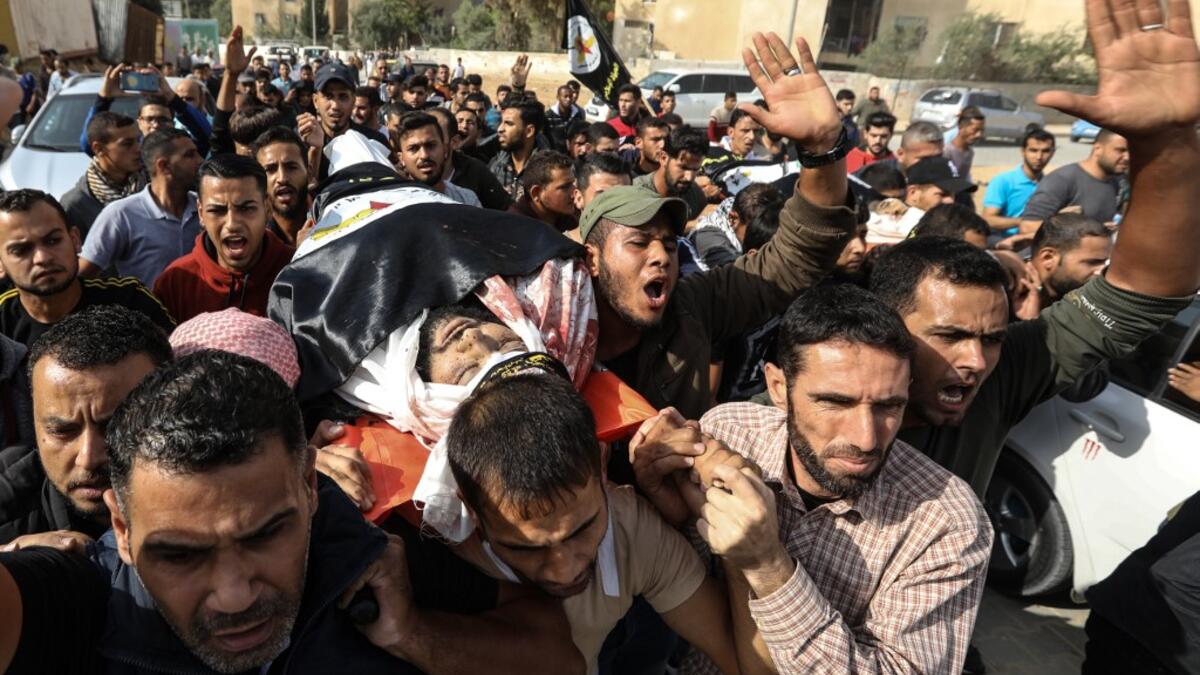 Palestinian mouners carry the body of Islamic Jihad militant Abdullah al-Belbasi during his funeral in Beit Hanun in the northern Gaza Strip on November 13, 2019. Two more Palestinians were killed in an Israeli strike in the Gaza Strip, the enclave's health ministry said, as Israel said it was targeting rocket-launching squads and militant sites. MAHMUD HAMS / AFP