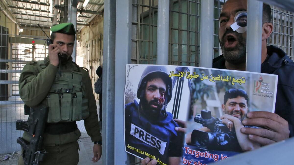 A Palestinian demonstrator takes part in a demonstration in support of Muath Amarneh, a photographer who was hit in the eye last week during clashes between Israeli border police and Palestinian demonstrators in the village of Surif, in front an Israeli checkpoint in the divided Palestinian city of Hebron on November 18, 2019. HAZEM BADER / AFP