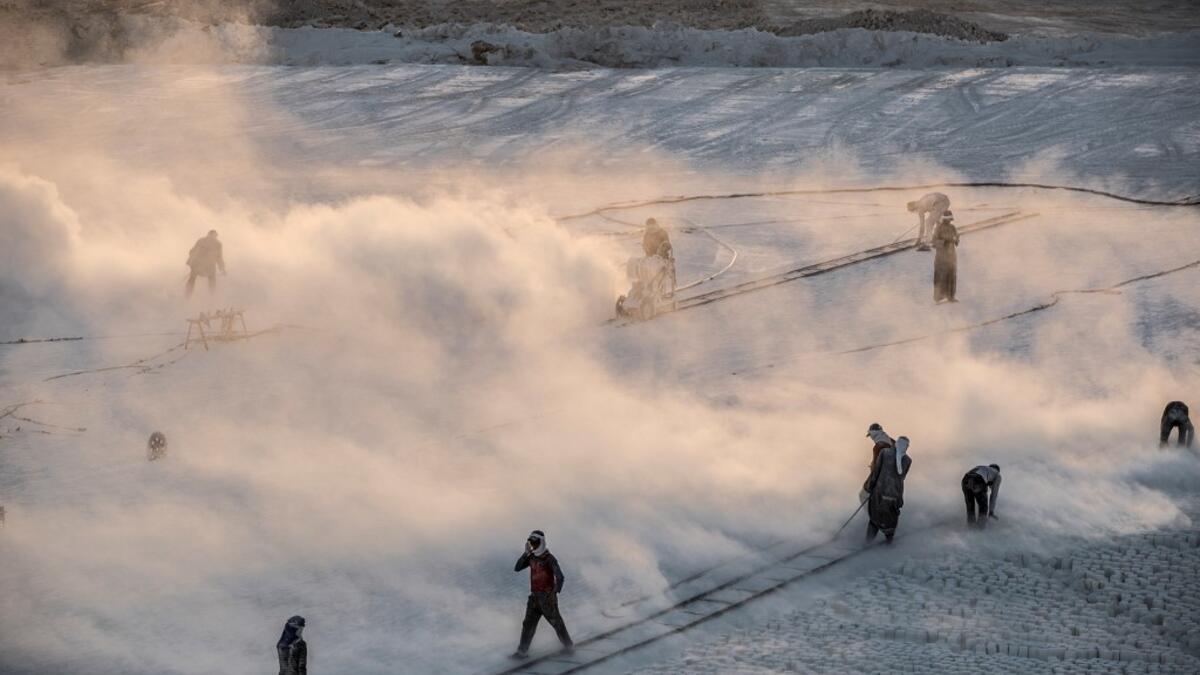Labourers work at the "White Mountain" limestone extraction quarry site near Egypt's southern city of Minya, some 265 kilometres south of the capital, on November 13, 2019. Covered in fine white dust, labourers at the so-called "White Mountain" off Minya toil in shifts amidst brutal conditions with little workplace safety for paltry pay. They handle dangerous machinery with finesse, and shrug off the dangers of a job where a mistake can prove fatal. Khaled DESOUKI / AFP
