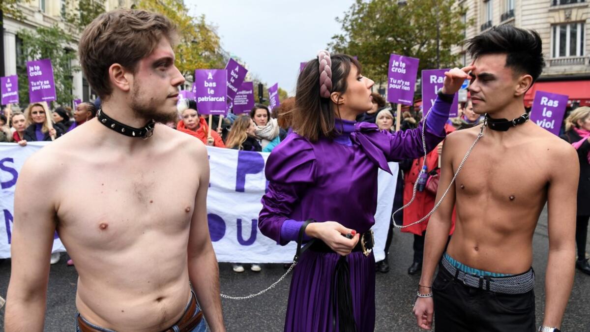 French comedian Marie Benoliel aka 'Marie S'Infiltre' (C) is seen during a protest to condemn violence against women, on November 23, 2019, in Paris. Alain JOCARD / AFP