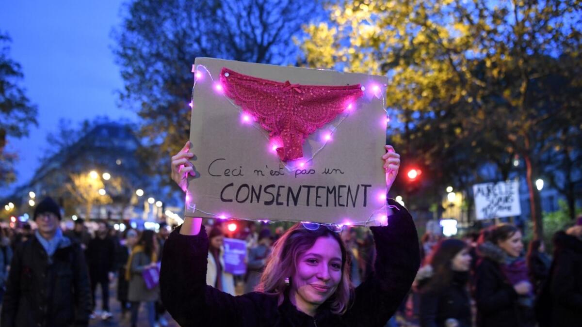 A woman holds a placard with a pasted knicker on it and reading "This is not consent" during a protest to condemn violence against women, on November 23, 2019, in Paris. Alain JOCARD / AFP