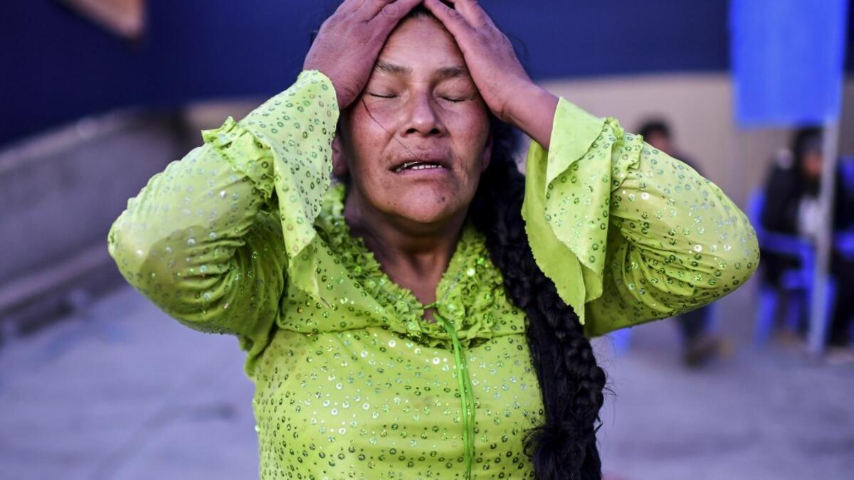 Bolivian wrestler Lidia Flores, aka "Dina, The Queen of the Ring", member of the Fighting Cholitas, gestures during a bout at Sharks of the Ring wrestling club in El Alto, Bolivia, on November 24, 2019. After a fortnight hiatus due to anti-government protests and blockades, the Fighting Cholitas are back in the ring. The unrest was triggered by the disputed October 20 election, which Evo Morales claimed to have won and opposition groups said was rigged. Ronaldo SCHEMIDT / AFP