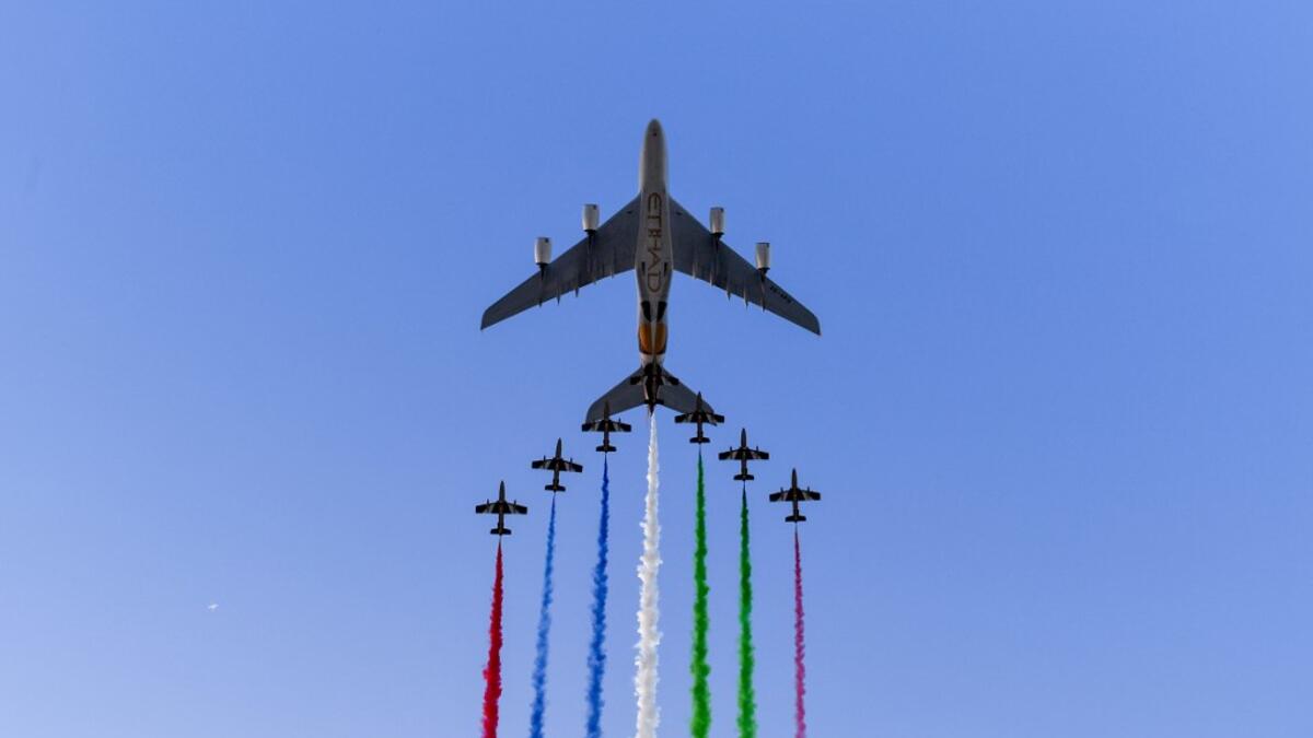 UAE elite aerobatic flying team "Al Fursan" escorts an Etihad A380 aircraft as they fly over the Yas Marina Circuit in Abu Dhabi, ahead of the final race of the Formula One Grand Prix season, on December 1, 2019. ANDREJ ISAKOVIC / AFP