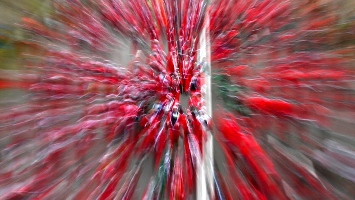 In this long exposure picture participants dressed as Santa Claus take part in Christmas traditional Santa Claus charity run, in Madrid, on December 8, 2019. GABRIEL BOUYS / AFP