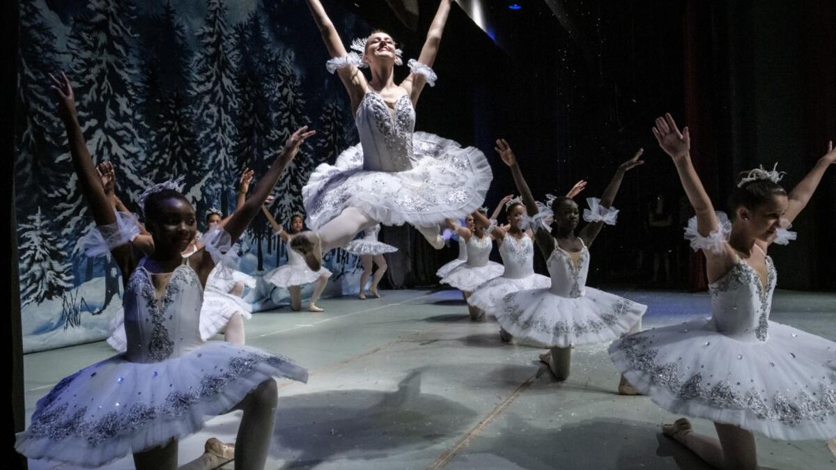 Members of Dance Centre Kenya (DCK) react in the wing stage during a production of the 'Nutcracker', a ballet primarily performed during the Christmas period as their annual show, along with the Nairobi Philharmonic Orchestra with foreign guest musicians at the National Heater in Nairobi, on December 8, 2019. DCK, founded by a few passionate families in early 2015, teach over 700 students at 3 studios in Nairobi, and provides lessons based on the Royal Academy of Dance Syllabus. Selected students in various