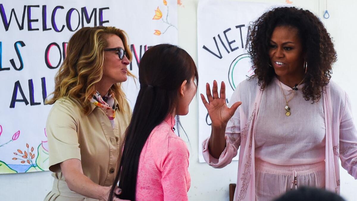 Former US First Lady Michelle Obama (R) and actress Julia Roberts (L) meet Vietnamese students in Can Giuoc district, Long An province on December 9, 2019. Michelle Obama and Julia Roberts visit to promote girls' education in Vietnam. Nhac NGUYEN / AFP