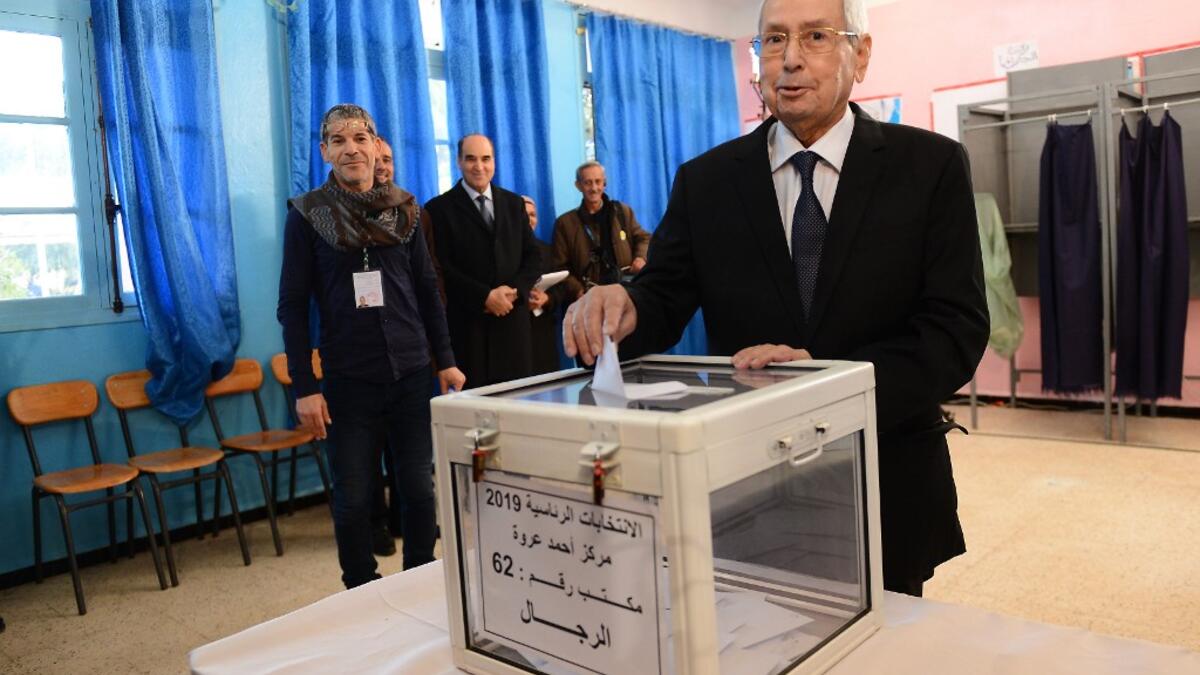 Algeria's interim president Abdelkader Bensalah casts his vote during the presidential election on December 12, 2019 at a polling station in Algiers. Five candidates are running in Algeria's presidential election to replace ousted Algerian president Abdelaziz Bouteflika. AFP