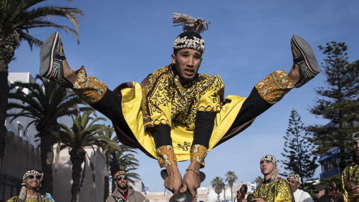 A Gnawa traditional group performs in the city of Essaouira on December 14, 2019, to celebrate the decision of adding the Gnawa culture to UNESCO's list of Intangible Cultural Heritage of Humanity. FADEL SENNA / AFP