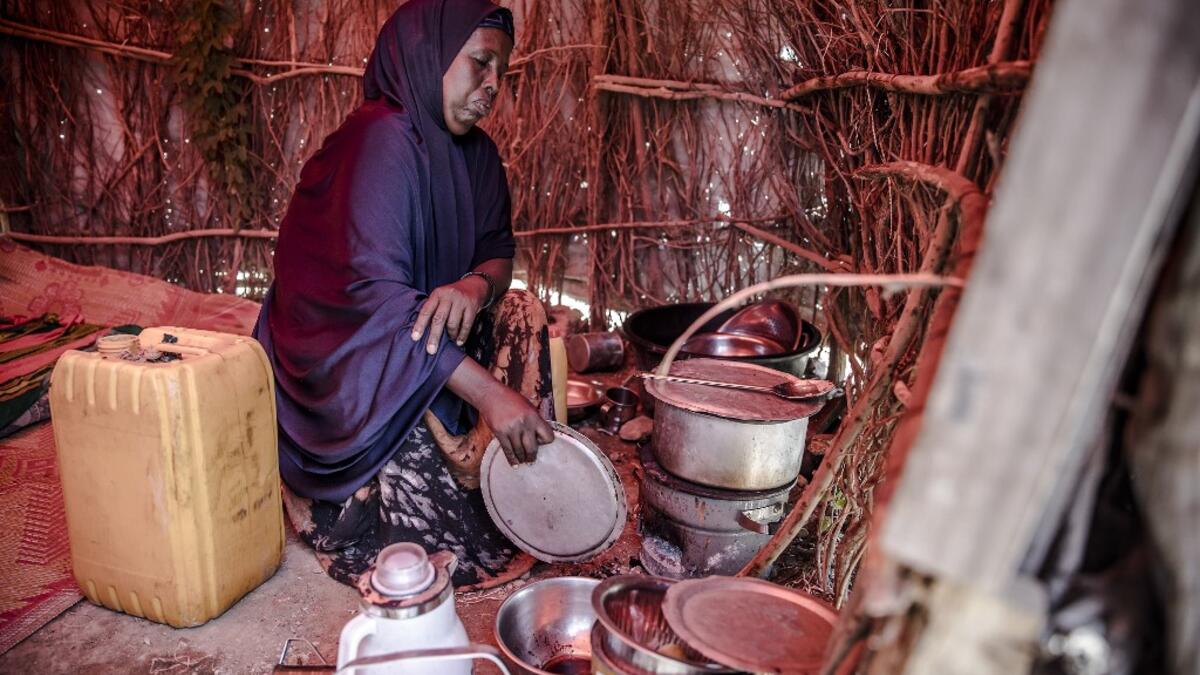 A displaced woman, who was forced to leave her house due to heavy rains and floods in the area, cooks a meal at a displacement camp for families affected by floods located in Beledweyne, Somalia, on December 14, 2019. The rains have inundated big areas surrounding Beledweyne area forcing thousands of people to leave their houses and look for humanitarian assistance while living in displacement camps. Due to climate change and human activities, floods have become more recurrent and completely unpredictable i