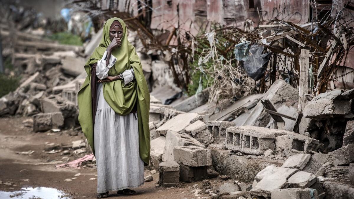 A woman reacts while looking at the destruction left after heavy rains and floods in the school in front of her house in Beledweyne, Somalia, on December 14, 2019. The rains have inundated big areas surrounding Beledweyne area forcing thousands of people to leave their houses and look for humanitarian assistance while living in displacement camps. Due to climate change and human activities, cycles of floods and droughts have become more recurrent and completely unpredictable in Somalia exposing hundreds of