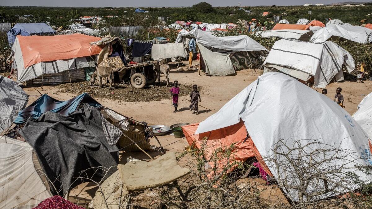 Two boys stand next to their tents at a displacement camp for people affected by intense flooding in Beledweyne, Somalia, on December 14, 2019. The rains have inundated big areas surrounding Beledweyne area forcing thousands of people to leave their houses and look for humanitarian assistance while living in displacement camps. Due to climate change and human activities, cycles of floods and droughts have become more recurrent and completely unpredictable in Somalia exposing hundreds of thousands of people