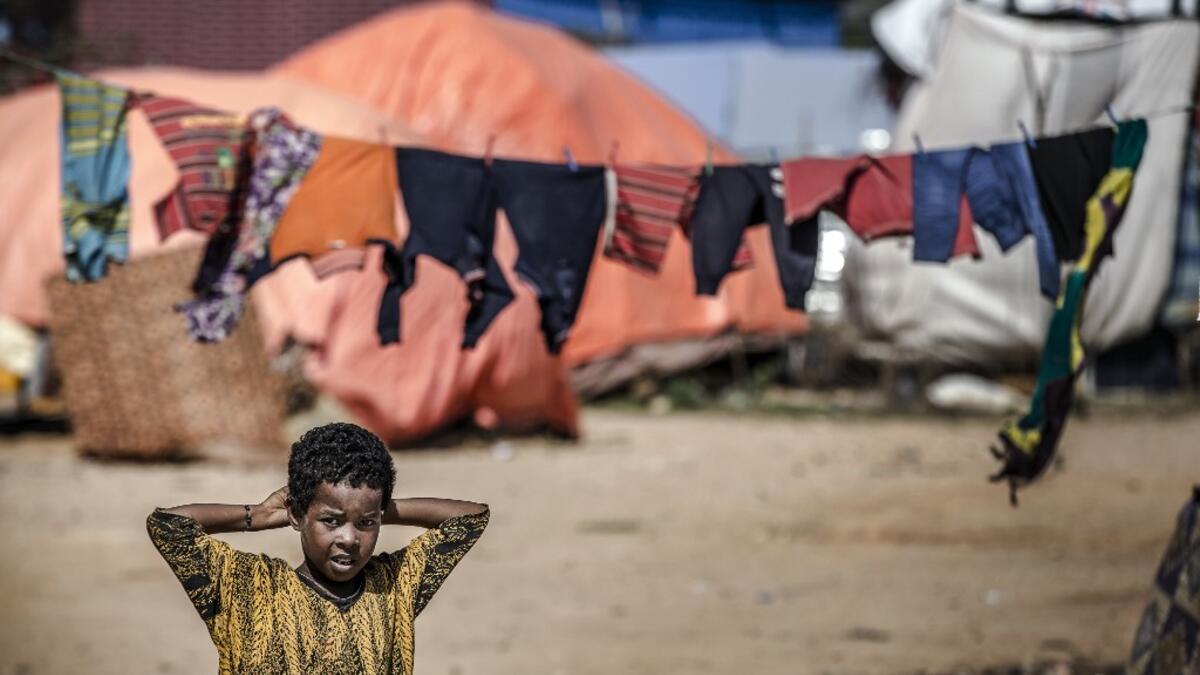 A girl stands next to her tent at a displacement camp for people affected by intense flooding in Beledweyne, Somalia, on December 14, 2019. The rains have inundated big areas surrounding Beledweyne area forcing thousands of people to leave their houses and look for humanitarian assistance while living in displacement camps. Due to climate change and human activities, cycles of floods and droughts have become more recurrent and completely unpredictable in Somalia exposing hundreds of thousands of people ever